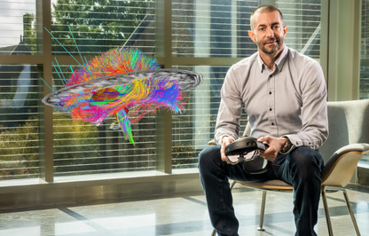 Cameron McIntyre with a hologram of a brain