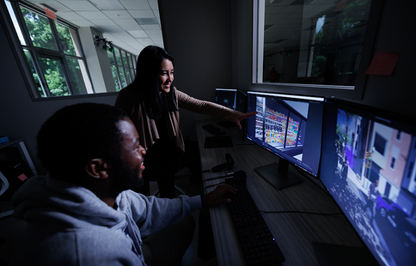 Scientists review footage on a computer.