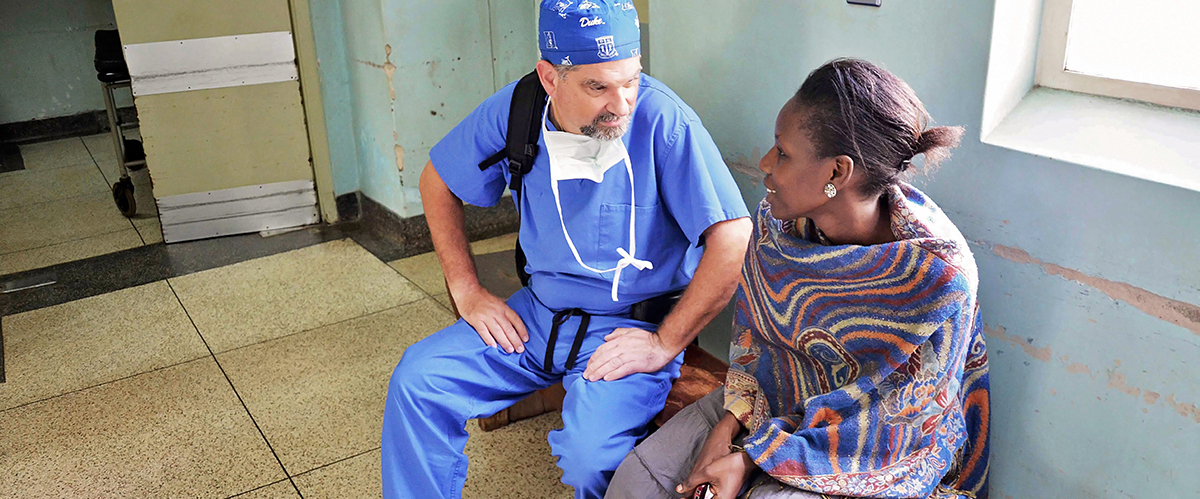 Dr. Haglund talks to a patient in a Ugandan hospital