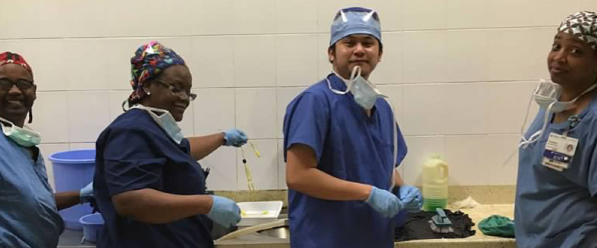 Four staff members sterilize equipment