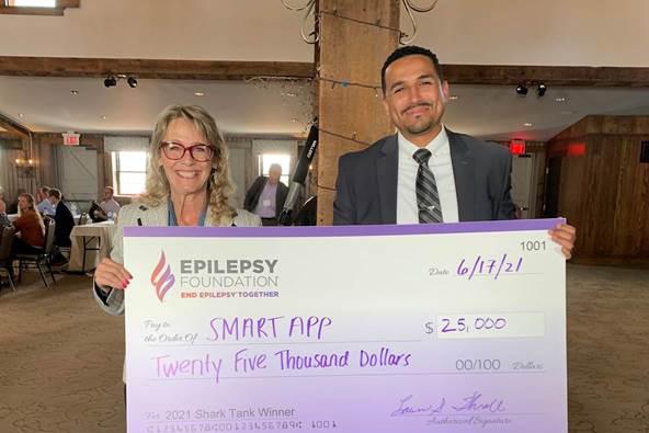 Deborah Koltai and, Tony Fuller holding a giant check