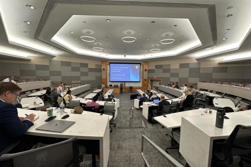 Faculty and residents presenting research in an amphitheater