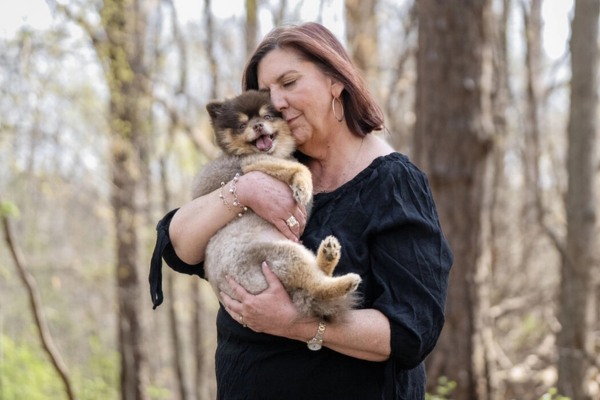 A woman hugging her dog.