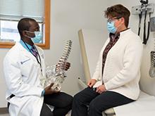 Dr. Karikari with a patient