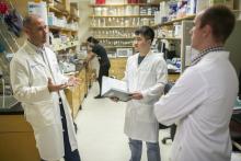 Dr. Fecci talks to members of his lab
