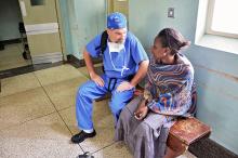 Dr. Haglund talks to a patient at a hospital in Uganda